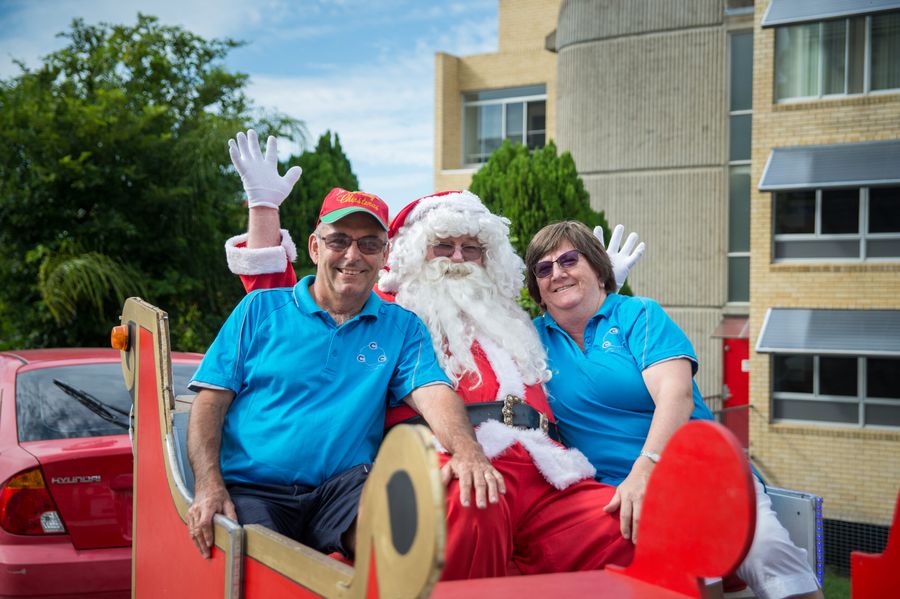Santa and volunteers on the sleigh with its reindeer