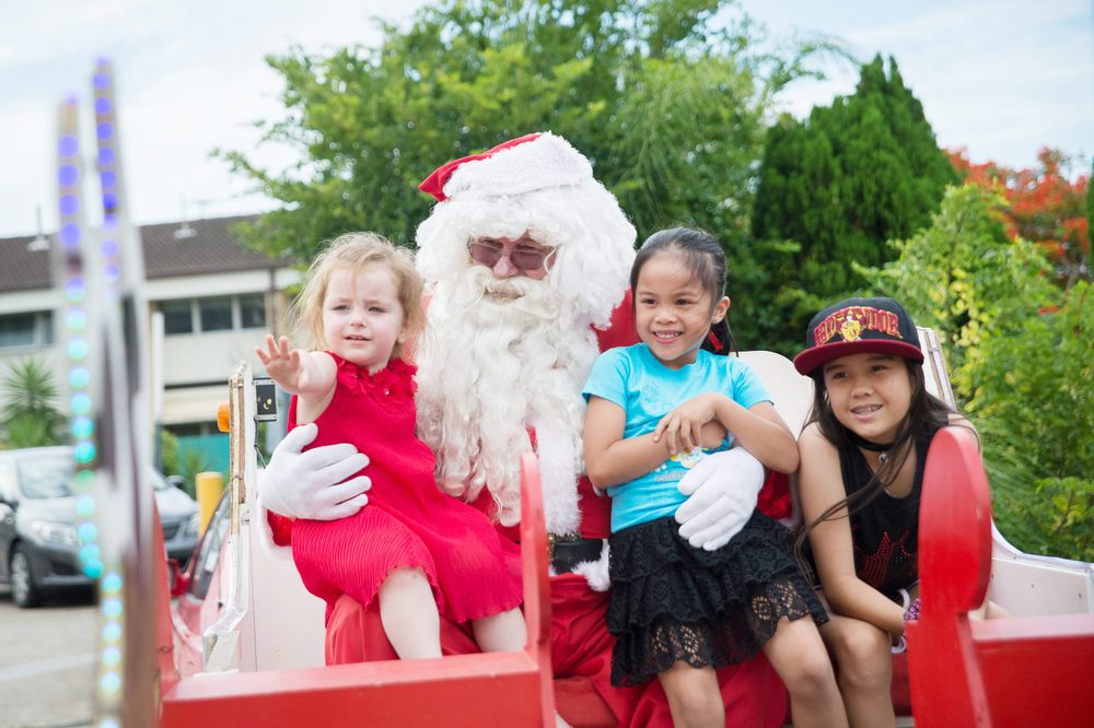 Santa on the sleigh with local children
